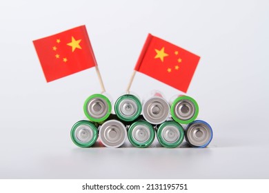 Battery. A lot of batteries on the background of the flag of the China. Alkaline and alkaline battery. Zinc and salt battery. Lithium import. Waste disposal.