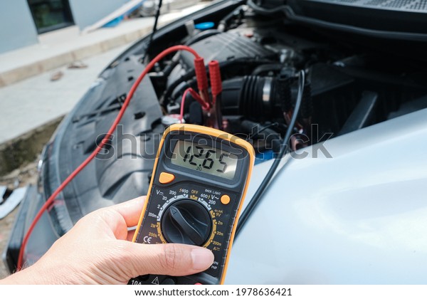 Battery\
car check with electric meter mechnic\
diagnostic