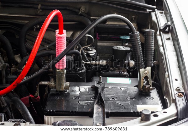 Battery charger and car\
in repair shop.