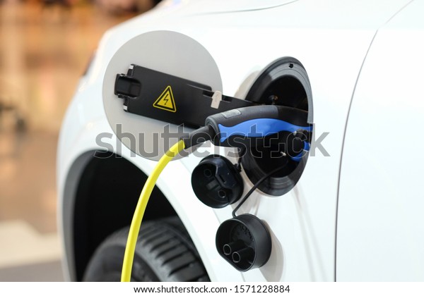 Battery charger in\
electric car at\
showroom