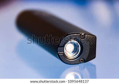 Battery from an electronic cigarette on a glass table