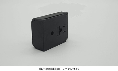 A battery pack for construction tools, isolated on a white background.  A black electronic device is shown on a white surface. It has slots and holes for connections. The device is designed for a specific function in technology or gadgets.