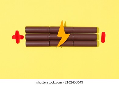 Battery in pattern on yellow background. Concept charging, environmental pollution, electrical devices. Flat lay