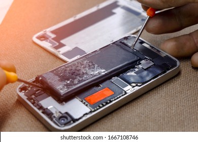 Battery removing by professional technician repairman for battery smartphone repair