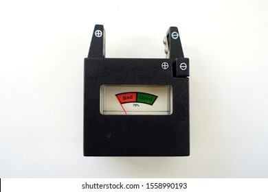 Battery Tester Against A White Background