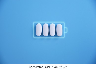 Battery and white pill medicine, energy for life, idea Battery charging symbol and capsules. Health and Technology, energy for life.