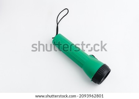 Battery-powered flashlight isolated on a white background. Copy space.