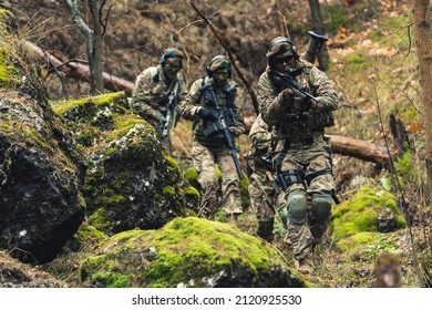 Battle ready armed ammunition squad sneaking into enemy territory
