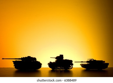 Battle tank driving on a sunset