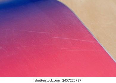 Battle Worn: Detailed Image of a Worn-Out Snowboard Surface: Capturing the Scratches on a Snowboard's Base - Powered by Shutterstock