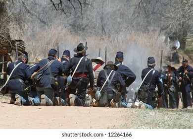 The "battlefield" is somewhat obscured by smoke as a line of Union troops prepare for continued battle at a reenactment in New Mexico