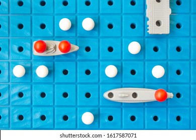 Battleship, Board Game. Sea Battle. Toy Ships On A Plastic Board. Perfect Hit. Victory Or Defeat. Strategy. Blue Background, Blur.