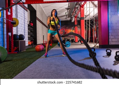 battling ropes girl at gym workout exercise fitted body