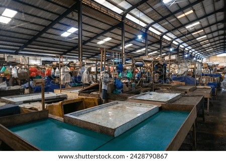 Batu 9 Fish Market, also known as Pasar Bintan Center. In one of the most famous fish markets in Tanjungpinang, the fish boxes are neatly organized and labeled with letters to prevent mix-ups