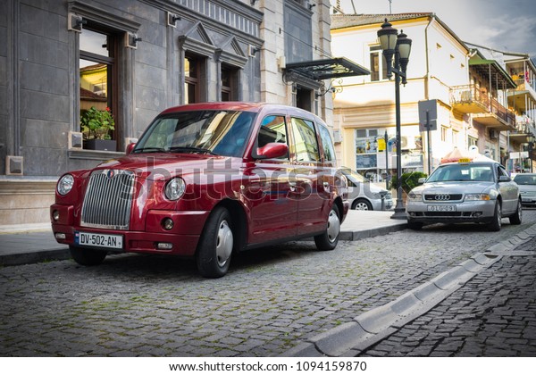 Batumi, Adjaria, Georgia - May 17 2018:\
old UK english taxi cab. Red vintage cabin taxi on the streets of\
European cozy little streets. Tourism\
concept