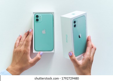 Batumi, Georgia. 27 July 2020 - Unpacking box of mint green iPhone 11 with dual camera of 2019 release. Apple gadgets     