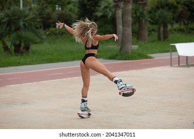 Batumi, Georgia - August 30, 2021. Kangoo jumps training. Woman in sportswear jumping in a kangoo jumps shoes.