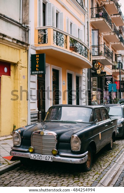 Batumi, Georgia - May 28, 2016: The Front\
View Of Black Rarity Retro Mercedes Benz Car Parked On The Narrow\
Paved Street In Summer Spring\
Daytime.