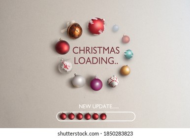 Baubles in the shape of a page loading icon with christmas loading banner in the centre and new update