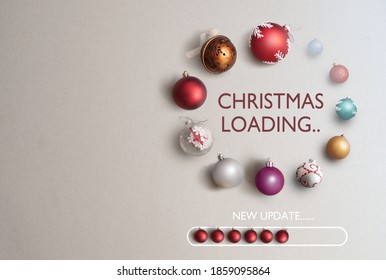 Baubles in the shape of a page loading icon with christmas loading banner in the centre and new update