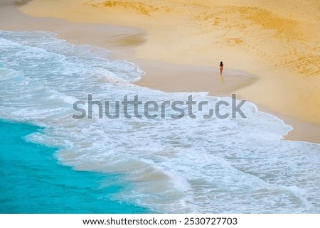 Bautiful beach rolling ocean waves and girl walking