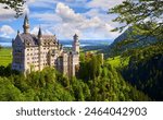 Bavaria, Germany. Fairytale Neuschwanstein Castle in Bavarian Alps mountains. Picturesque view at green forest trees, lake sunrise sky with clouds. Famous neuschwanstein landmark travel destination