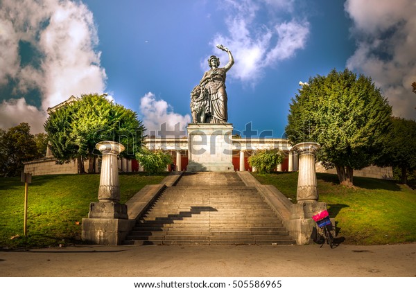 Bavaria\
Statue Woman Iconic Ruhmeshalle Outdoors Landmark Daytime Old Blue\
Sky Clouds Travel Tourist Munich Germany\
Europe