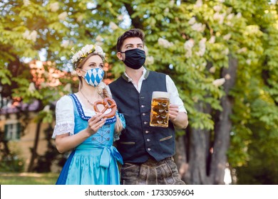 Bavarian couple during the coronavirus crisis with beer and pretzel