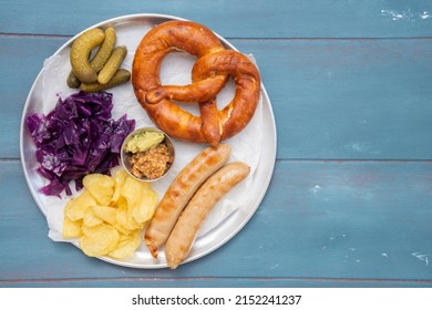 Bavarian Dish Sausage With Pretzel, Mustard, Braised Red Cabbage, Pickles And Potato Chips