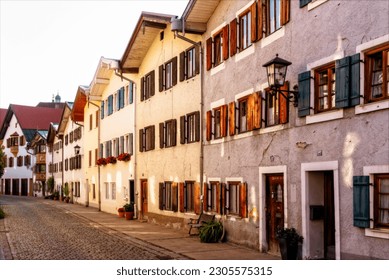 Bavarian houses lined up in vanishing point perspective in the warm afternoon light of the sun