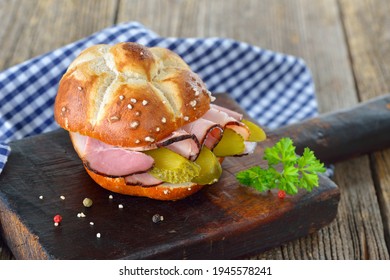 Bavarian lye roll sandwich with smoked country ham and sliced pickles