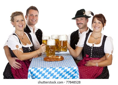 Bavarian Men And Women Toast With Oktoberfest Beer Stein. Isolated On White Background.