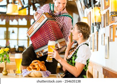 Bavarian restaurant with music, guests, wheat beer and pretzels