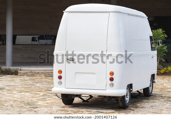 Bavaro, Dominican Republic - January 15, 2020:\
Volkswagen Type 2 rear view, custom trade bus modification. White\
light commercial vehicle on a sunny\
day
