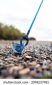 Bawdsey, Suffolk, UK January 06 2021: An Adult Male Doing A Beach Clean And Picking Up Litter And Discarded Rubbish. Litter Pick, Environmental, Beach Clean Concept