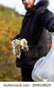 Bawdsey, Suffolk, UK January 06 2021: An Adult Male Doing A Beach Clean And Picking Up Litter And Discarded Rubbish. Litter Pick, Environmental, Beach Clean Concept