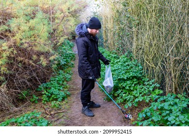 Bawdsey, Suffolk, UK January 06 2021: An Adult Male Doing A Beach Clean And Picking Up Litter And Discarded Rubbish. Litter Pick, Environmental, Beach Clean Concept