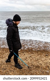 Bawdsey, Suffolk, UK January 06 2021: An Adult Male Doing A Beach Clean And Picking Up Litter And Discarded Rubbish. Litter Pick, Environmental, Beach Clean Concept