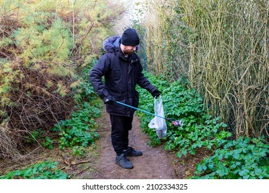 Bawdsey, Suffolk, UK January 06 2021: An Adult Male Doing A Beach Clean And Picking Up Litter And Discarded Rubbish. Litter Pick, Environmental, Beach Clean Concept