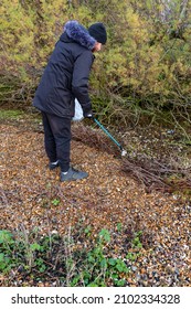 Bawdsey, Suffolk, UK January 06 2021: An Adult Male Doing A Beach Clean And Picking Up Litter And Discarded Rubbish. Litter Pick, Environmental, Beach Clean Concept