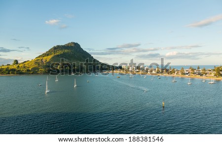 The bay and harbour at Tauranga with calm water in front of the Mount