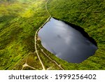 Bay Lough lake in Clogheen, county Tipperary in Ireland. The lake sits on a slope in the midst of the Knockmealdown mountains, looks like a mirror due to its black water.