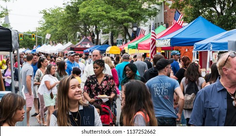 Bay Shore, NY, USA - 10 June 2018: The Hamlet of Bay shore on Long Island streets are crowded with vendors and people during their annual community street fair.