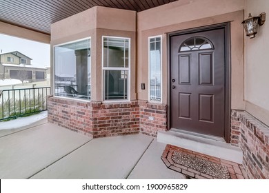 Bay Window And Glass Paned Wood Front Door At The Facade Of Home With Brick Wall