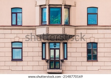 Bay window and several windows in a row on the facade of the urban historic apartment building front view, Saint Petersburg, Russia