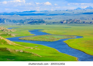 Bayinbuluke grassland natural scenery in Xinjiang,China.The winding river is on the green grassland.