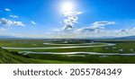 Bayinbuluke Grassland and winding river natural scenery in Xinjiang,China.The winding river is on the green grassland.