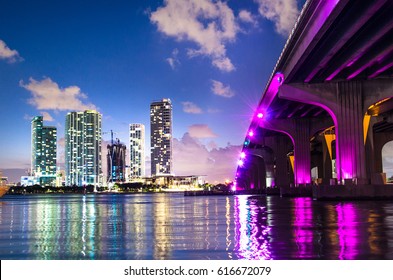 Bayside Marketplace shot from under the Venetian Causeway bridge, which is illuminated in pink