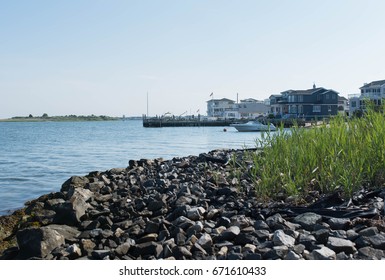 Bayside photo of the Atlantic Ocean on Long Beach Island, New Jersey with houses and boats along the shore.