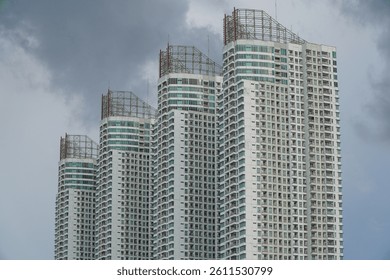 Baywalk Apartment Building Shot From Muara Angke Port Featuring Unique Architectural Design Against Clouds